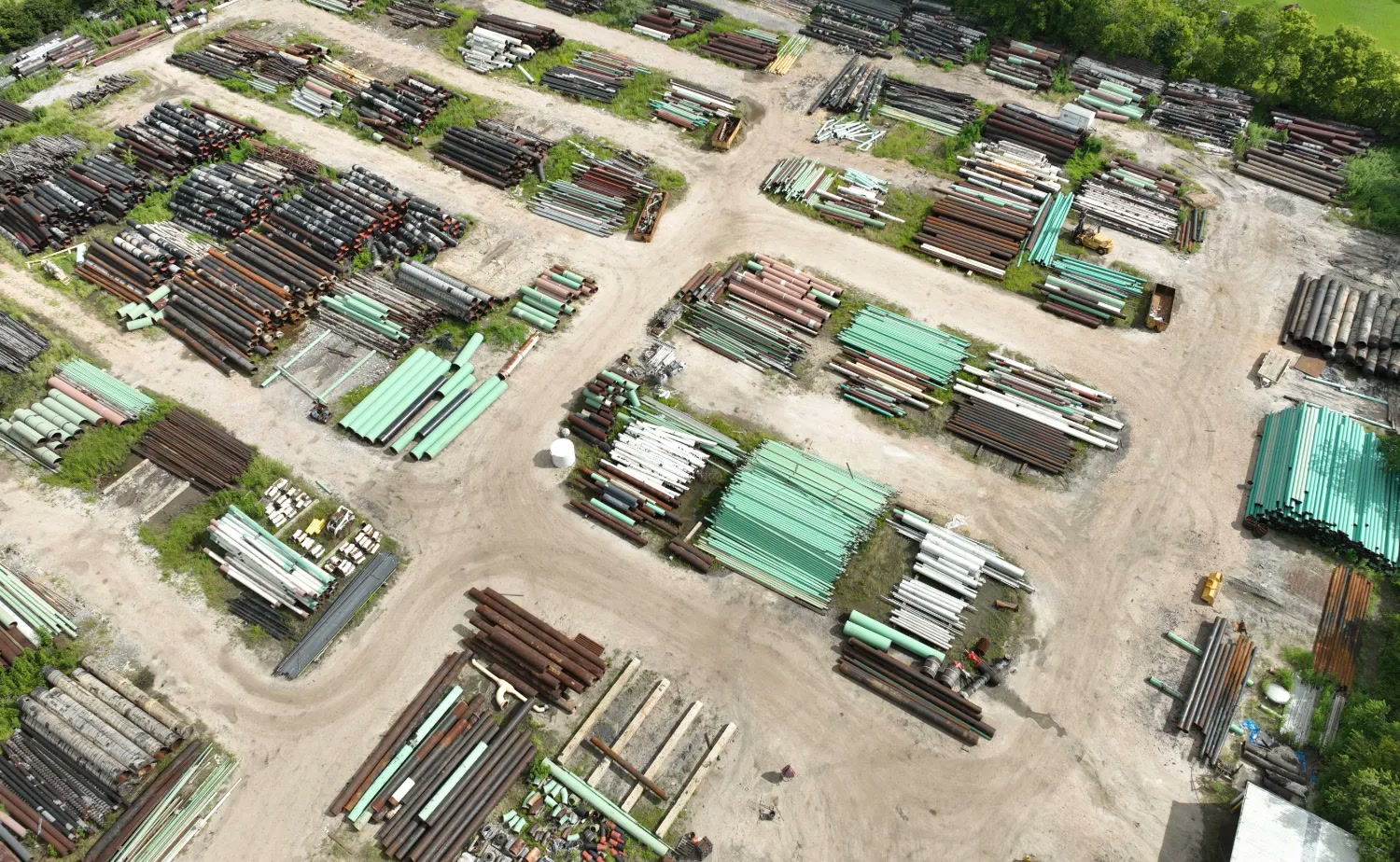 Aerial view of the SWPS pipe yard, rows of recovered and surplus steel pipe sorted by size and coating